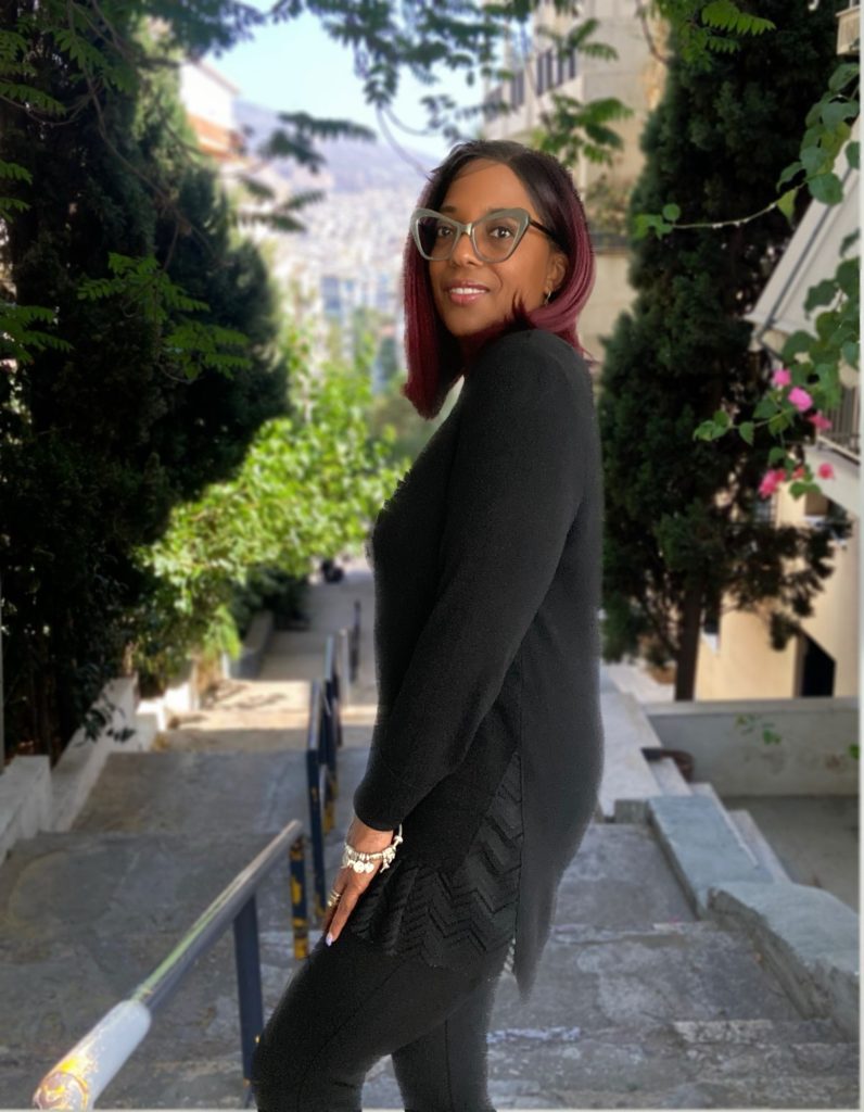 Black woman walking confidently through a city street